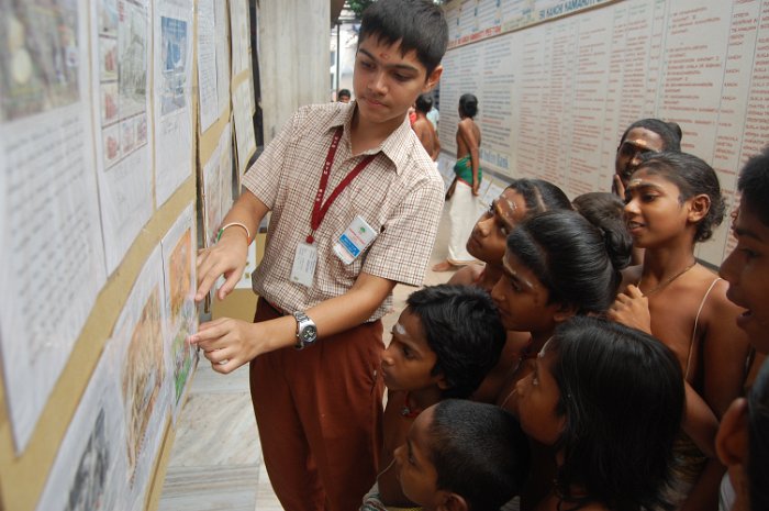 A student explaining about the stamps to Agama Patasala Vidyarthis